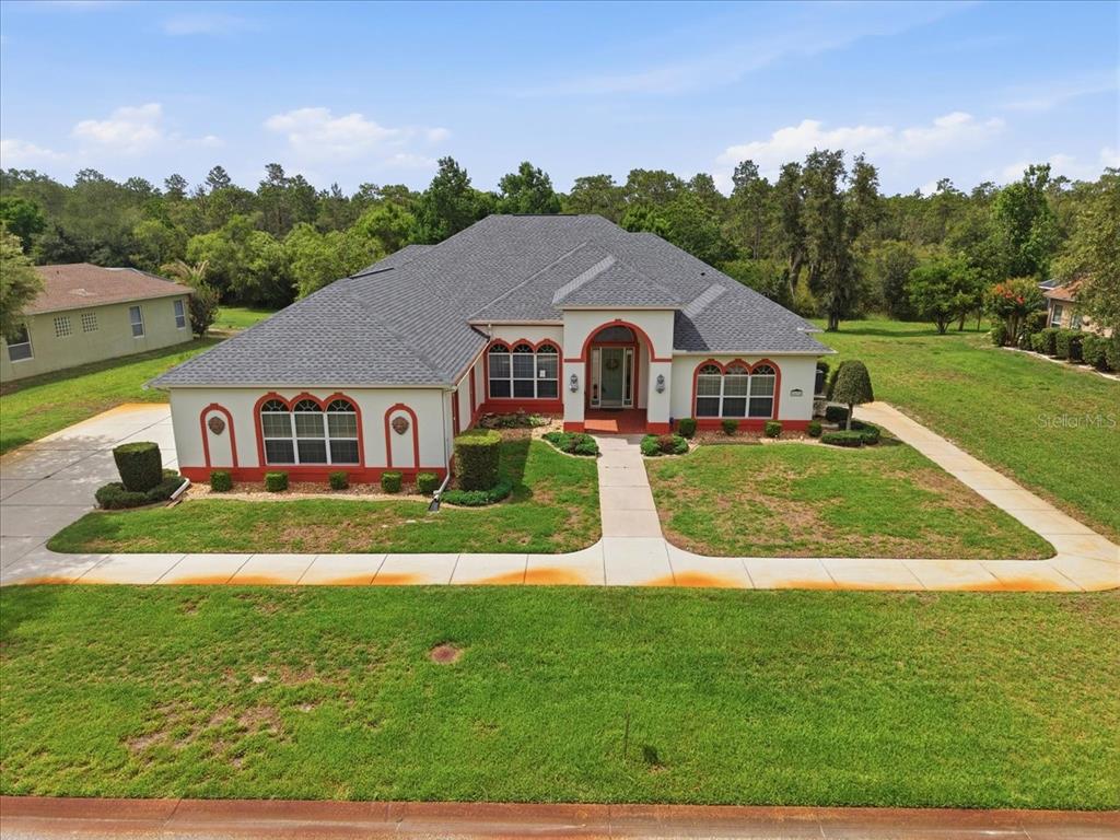 An aerial view of a single-story house with a gray roof and white stucco exterior — 8698 MISSISSIPPI RUN, WEEKI WACHEE, FL