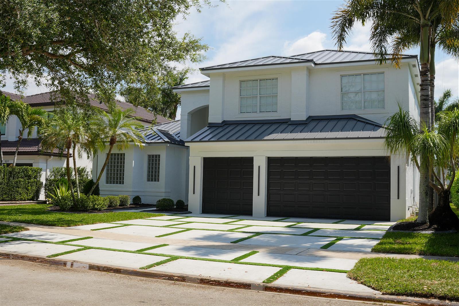 A two-story white house with a dark metal roof and a grid-patterned concrete driveway — 5227 SW 195th Terrace, Miramar FL 33029, MIRAMAR, FL