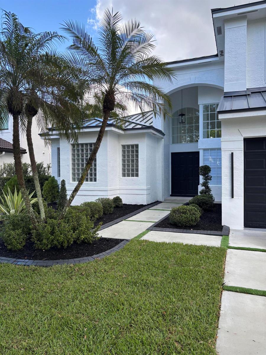 A white two-story house features a black front door, glass block windows, and palm trees — 5227 SW 195th Terrace, Miramar FL 33029, MIRAMAR, FL