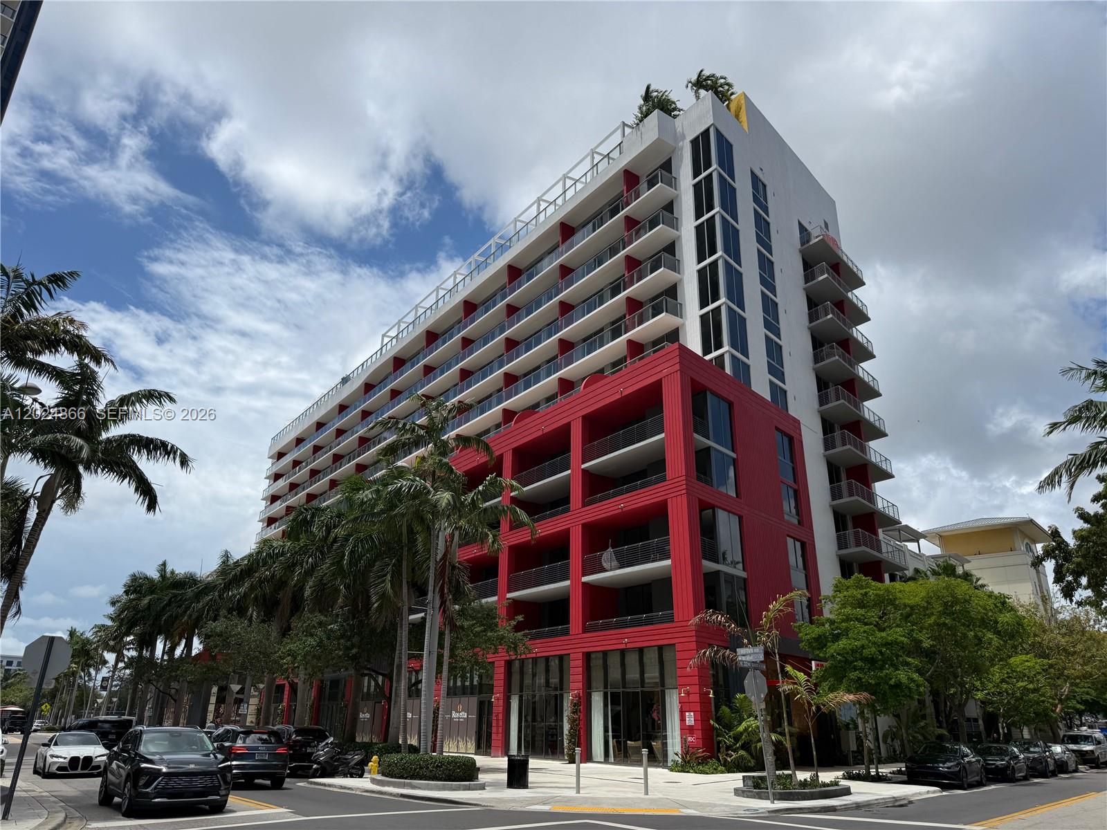 A modern multi-story building features a prominent red facade section and white balconies — 90 NE 32 # 412, Miami FL 33137, MIAMI, FL