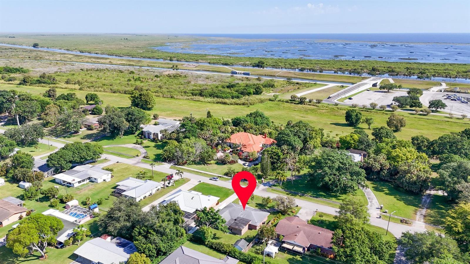 An aerial view shows a residential neighborhood with a red location pin on a house — 534 E Del Monte Avenue, Clewiston FL 33440, CLEWISTON, FL