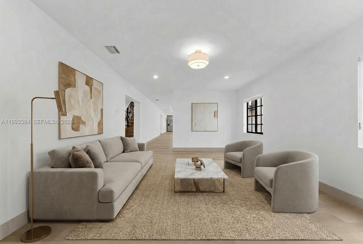 This living room features a neutral sofa, two armchairs, a marble coffee table, and artwork — 456 SW 20th Rd # 458, Miami FL 33129, MIAMI, FL