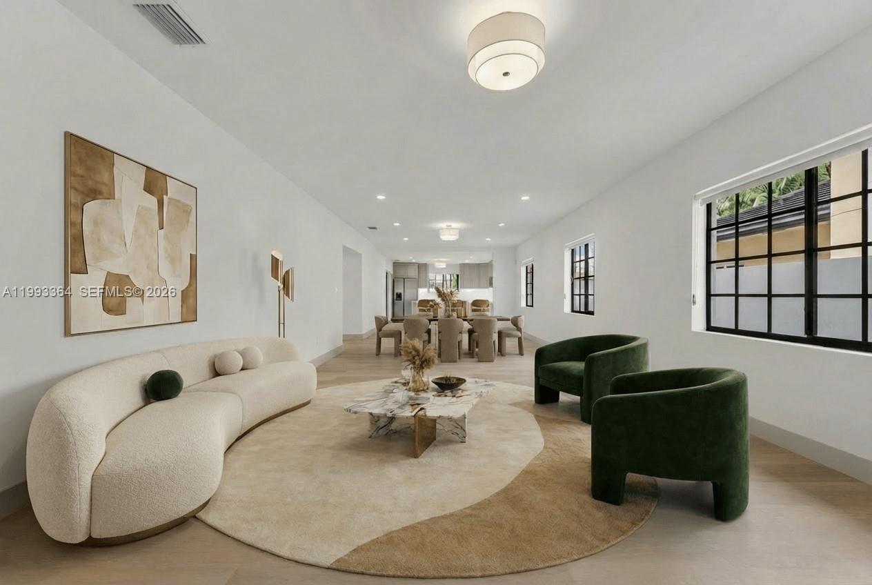 This living and dining area features a curved sofa, green armchairs, and light flooring — 456 SW 20th Rd # 458, Miami FL 33129, MIAMI, FL