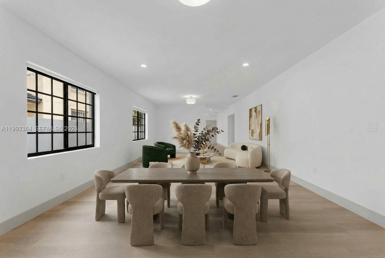 A dining area with a wooden table and chairs opens into a living room space — 456 SW 20th Rd # 458, Miami FL 33129, MIAMI, FL