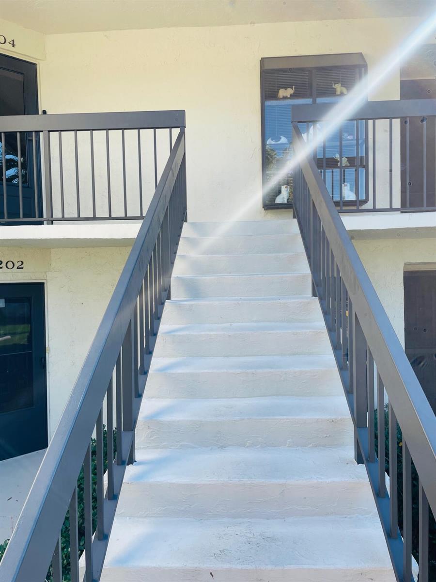 An exterior view of a concrete staircase leading to the second-floor landing of a building — 3204 Perimeter Drive # 3204, FL 33467, FL