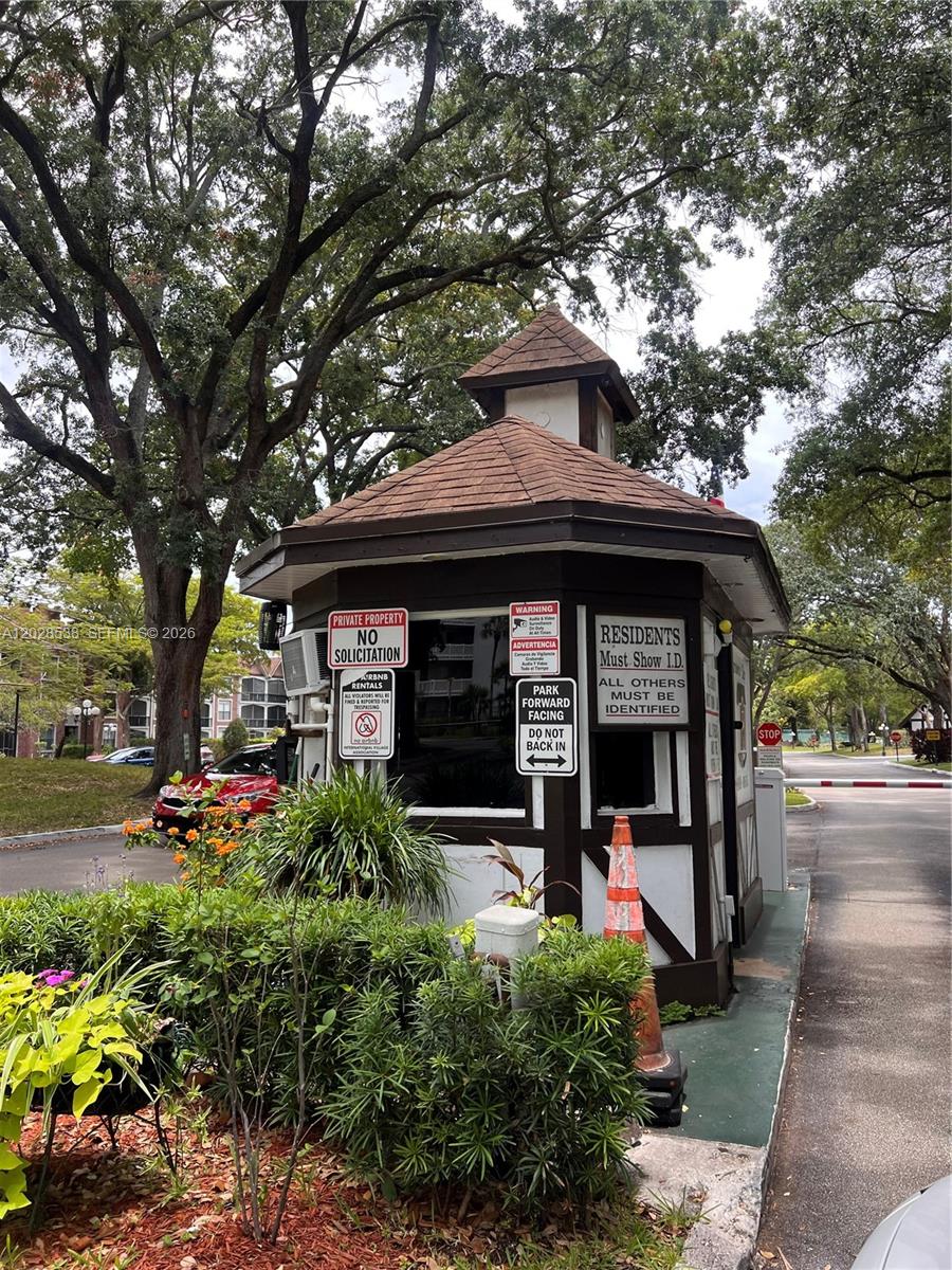 A small, brown and white guardhouse sits at the entrance of a gated community — 3760 Inverrary Dr # 2A, Lauderhill FL 33319, LAUDERHILL, FL