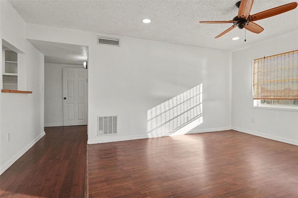 A room with white walls, wood-look flooring, a ceiling fan, and a window with blinds — 2535 N ALAFAYA TRAIL UNIT 66, ORLANDO, FL
