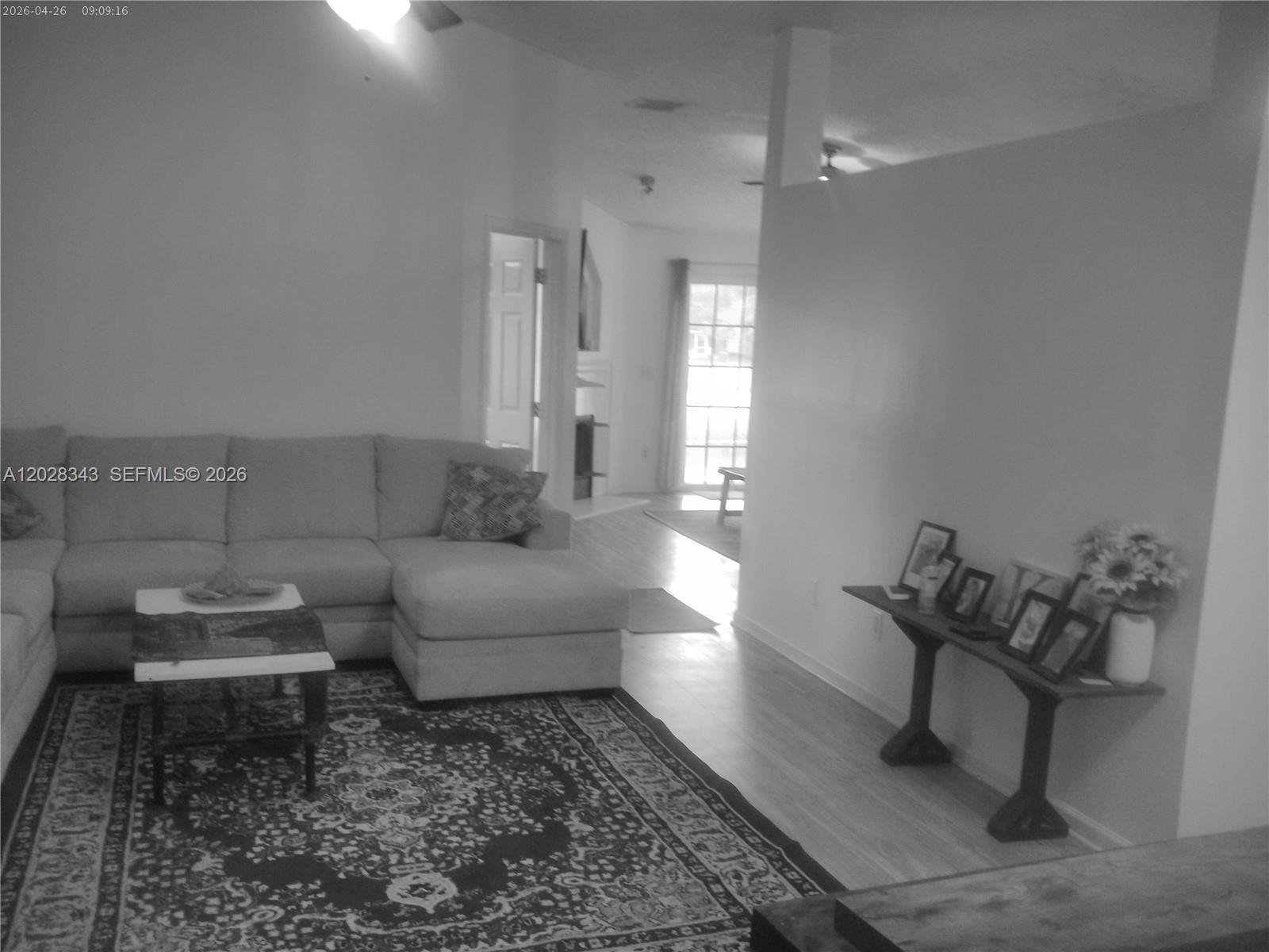 A living room features a sectional sofa, an area rug, and a console table — 1641 spring oaks ln, Jacksonville FL 32221, JACKSONVILLE, FL