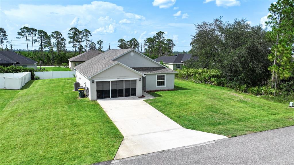 An aerial view shows a single-story house with a concrete driveway and a screened garage — 5906 ESCALON DRIVE, SEBRING, FL