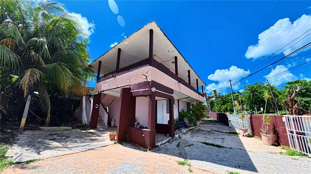 A two-story house with a pink and brown exterior features a large covered balcony — 696 CALLE PRINCIPAL UNIT 508, DORADO, PR
