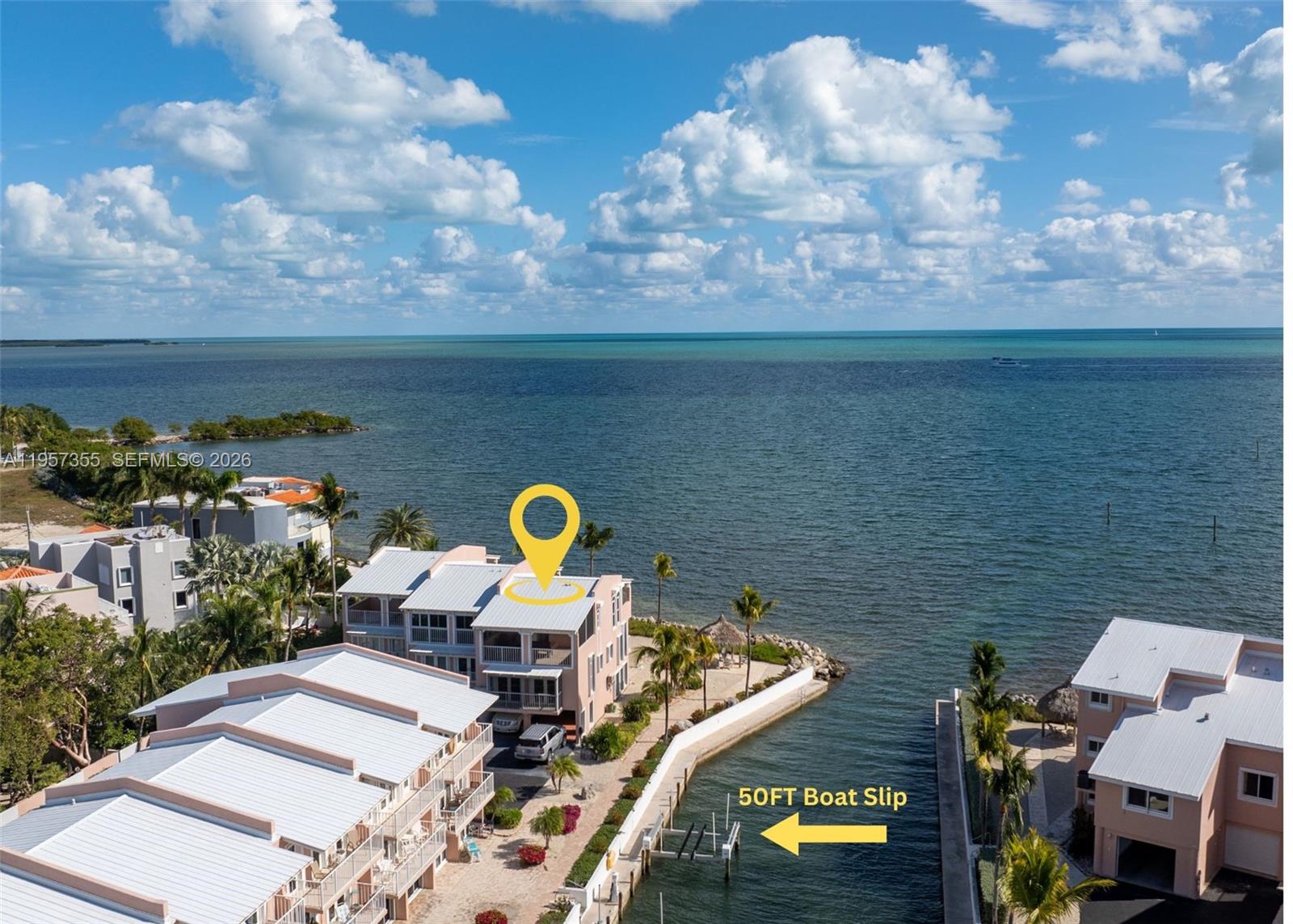 An aerial view shows waterfront townhomes with a designated 50-foot boat slip on the canal — 1501 Ocean Bay Dr # A1, Key Largo FL 33037, KEY LARGO, FL