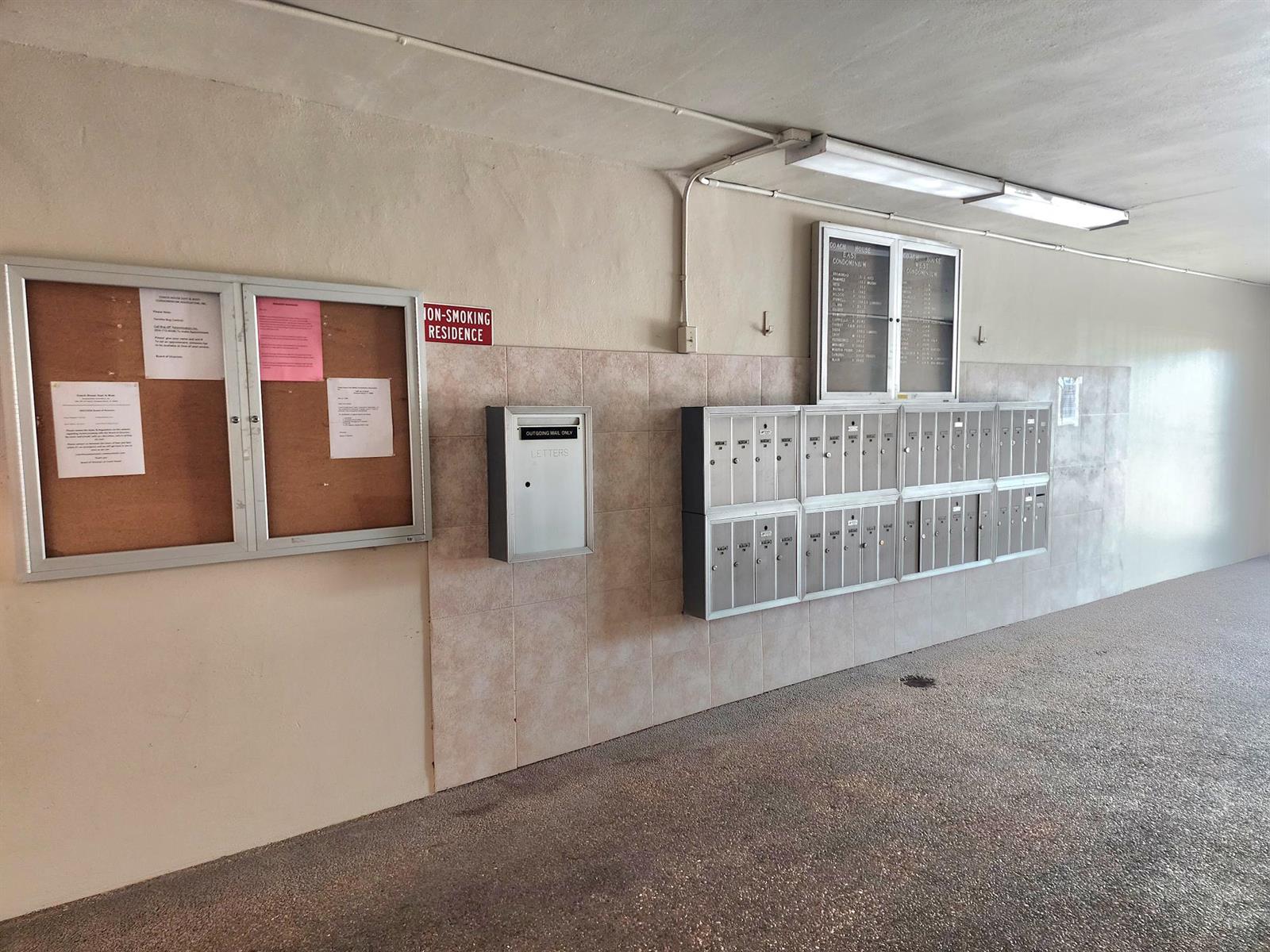 A hallway features a bulletin board, a mail collection box, and rows of metal mailboxes — 2301 NE 14th St Causeway # 305e, Pompano Beach FL 33062, POMPANO BEACH, FL
