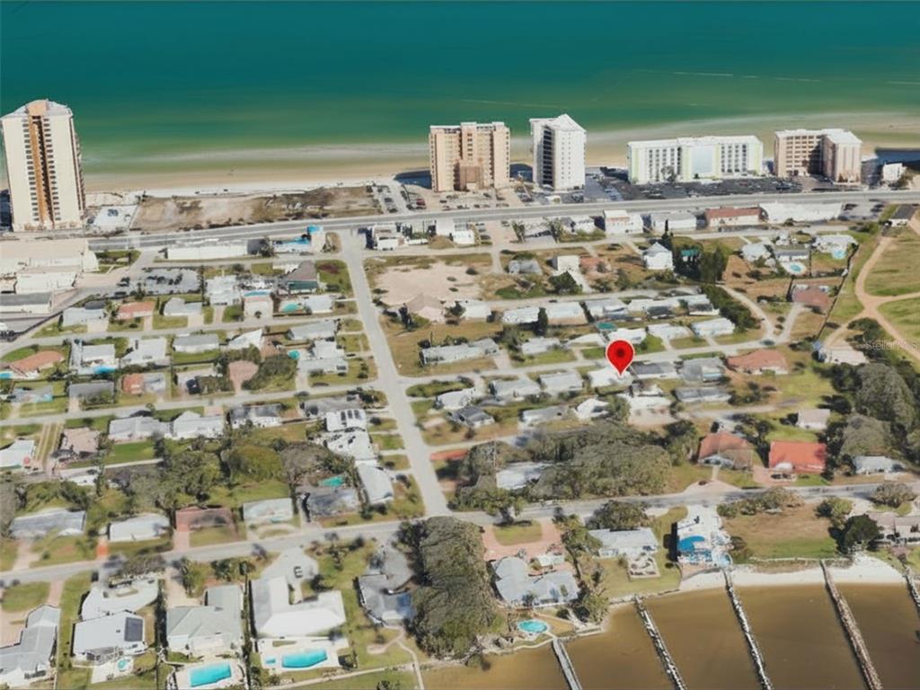 An aerial view shows a residential neighborhood near a beach with a red location pin — 3114 ESPERANZA AVENUE, DAYTONA BEACH SHORES, FL