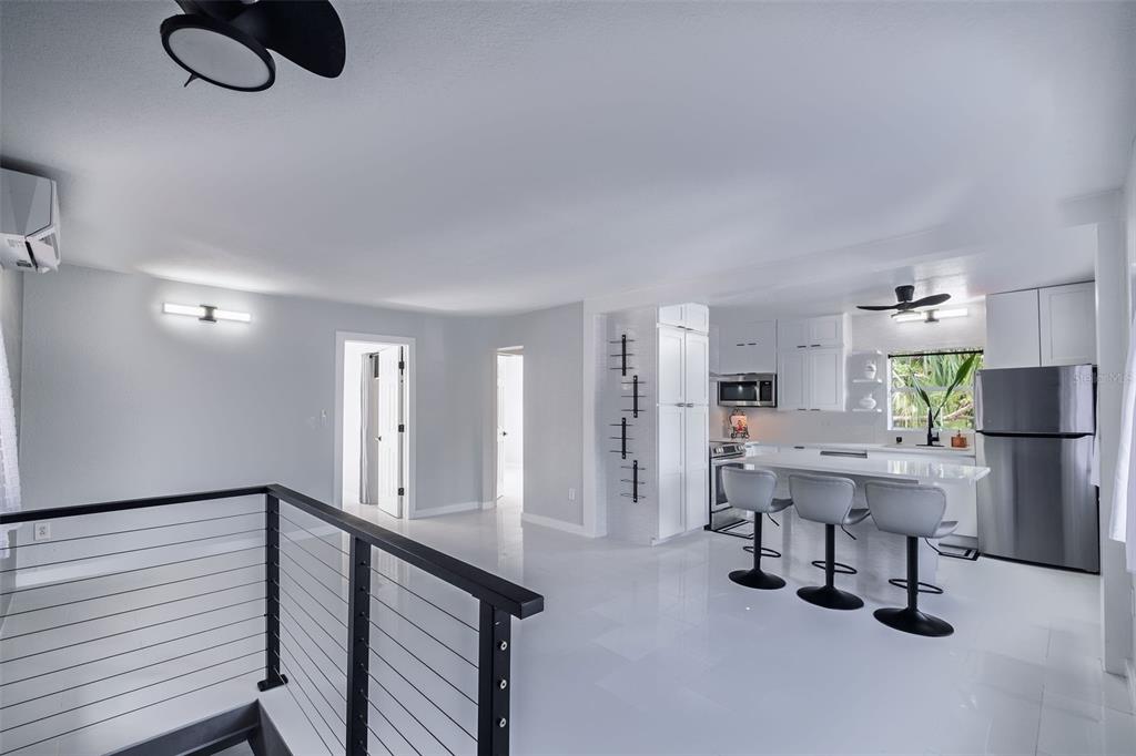 A modern kitchen features white cabinets, stainless steel appliances, and a window above the sink — 1427 ASHER LANE, ORLANDO, FL