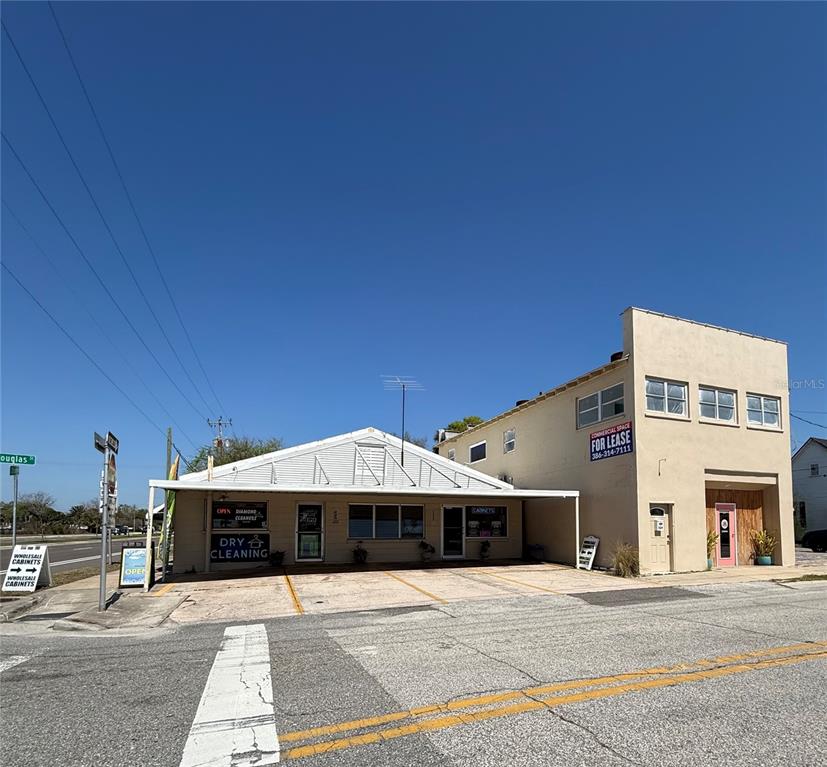A low-slung commercial building with a dry cleaner and a two-story section for lease — 225 S DIXIE FREEWAY, NEW SMYRNA BEACH, FL