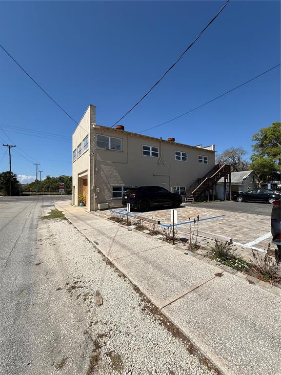 A two-story tan commercial building features a side staircase and a paved parking lot — 225 S DIXIE FREEWAY, NEW SMYRNA BEACH, FL