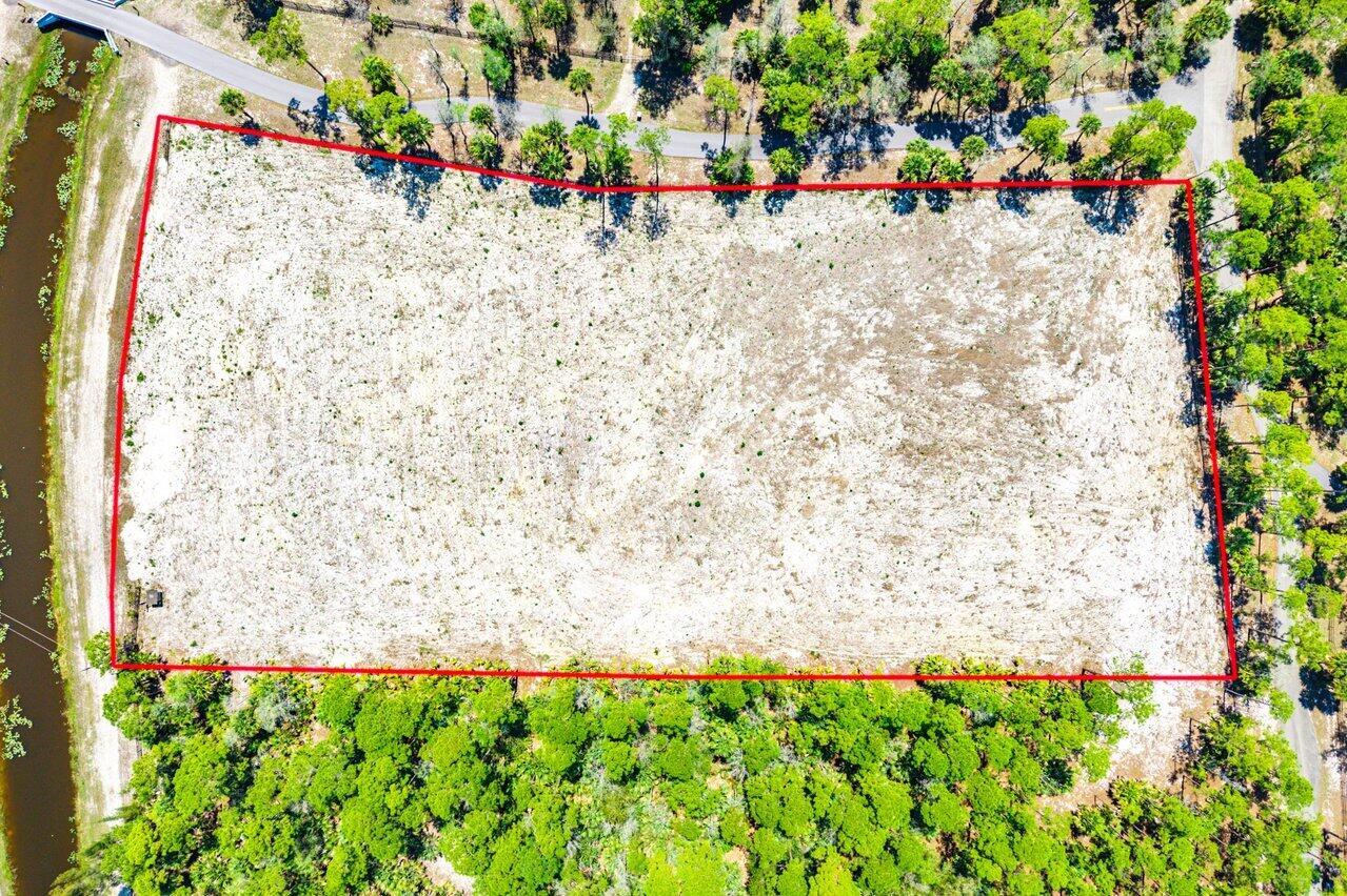 An aerial view shows a rectangular, cleared sandy lot bordered by trees and a road — 1278 Arabian Drive, Loxahatchee FL 33470, LOXAHATCHEE, FL