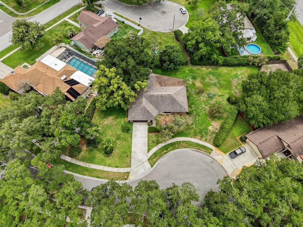 An aerial view shows a suburban house with a driveway, yard, and surrounding trees — 1405 LAUREL COURT, PLANT CITY, FL
