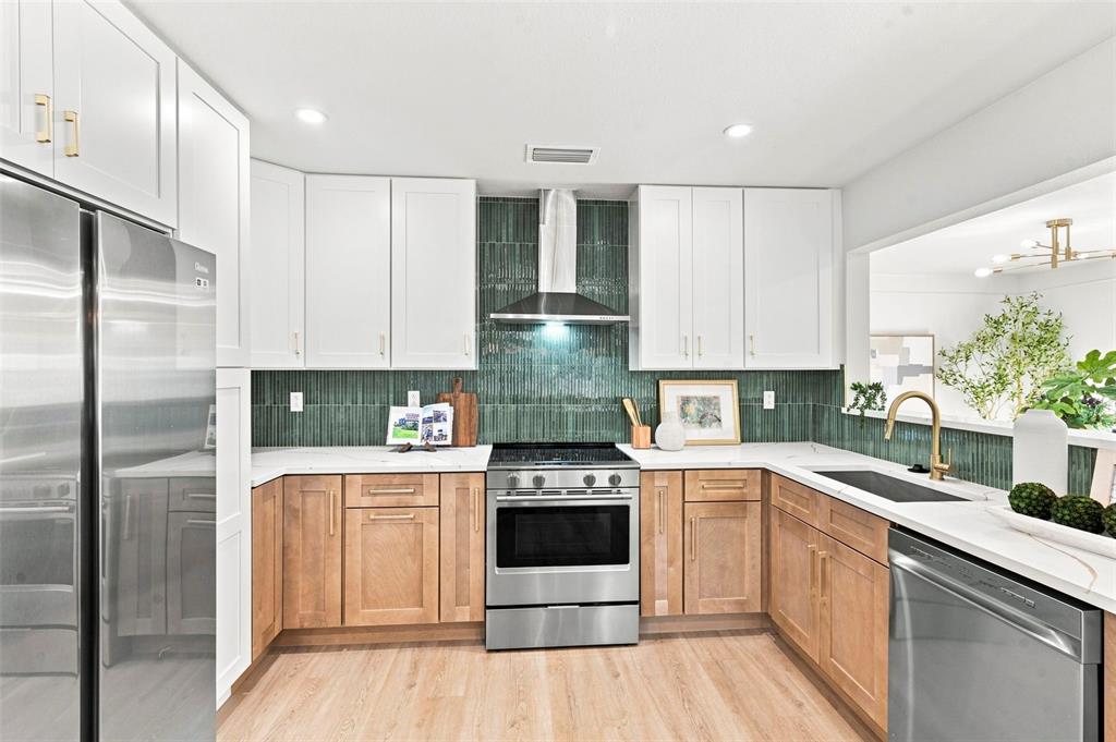 A kitchen features white upper cabinets, wood lower cabinets, and a green vertical tile backsplash — 7326 11TH AVENUE N, ST PETERSBURG, FL