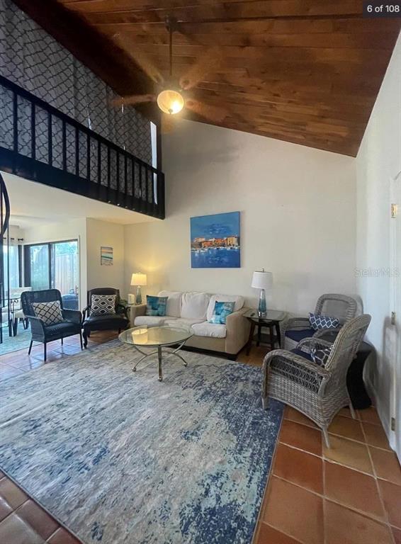 A living room features a vaulted wood ceiling, a loft, and a large area rug — 109 PASS KEY ROAD UNIT 109, SARASOTA, FL