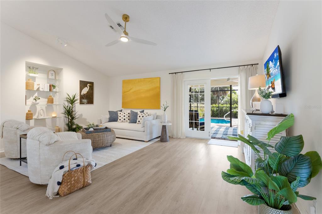 A screened-in swimming pool with a brick paver deck and palm trees in the background — 5107 86TH STREET COURT W, BRADENTON, FL