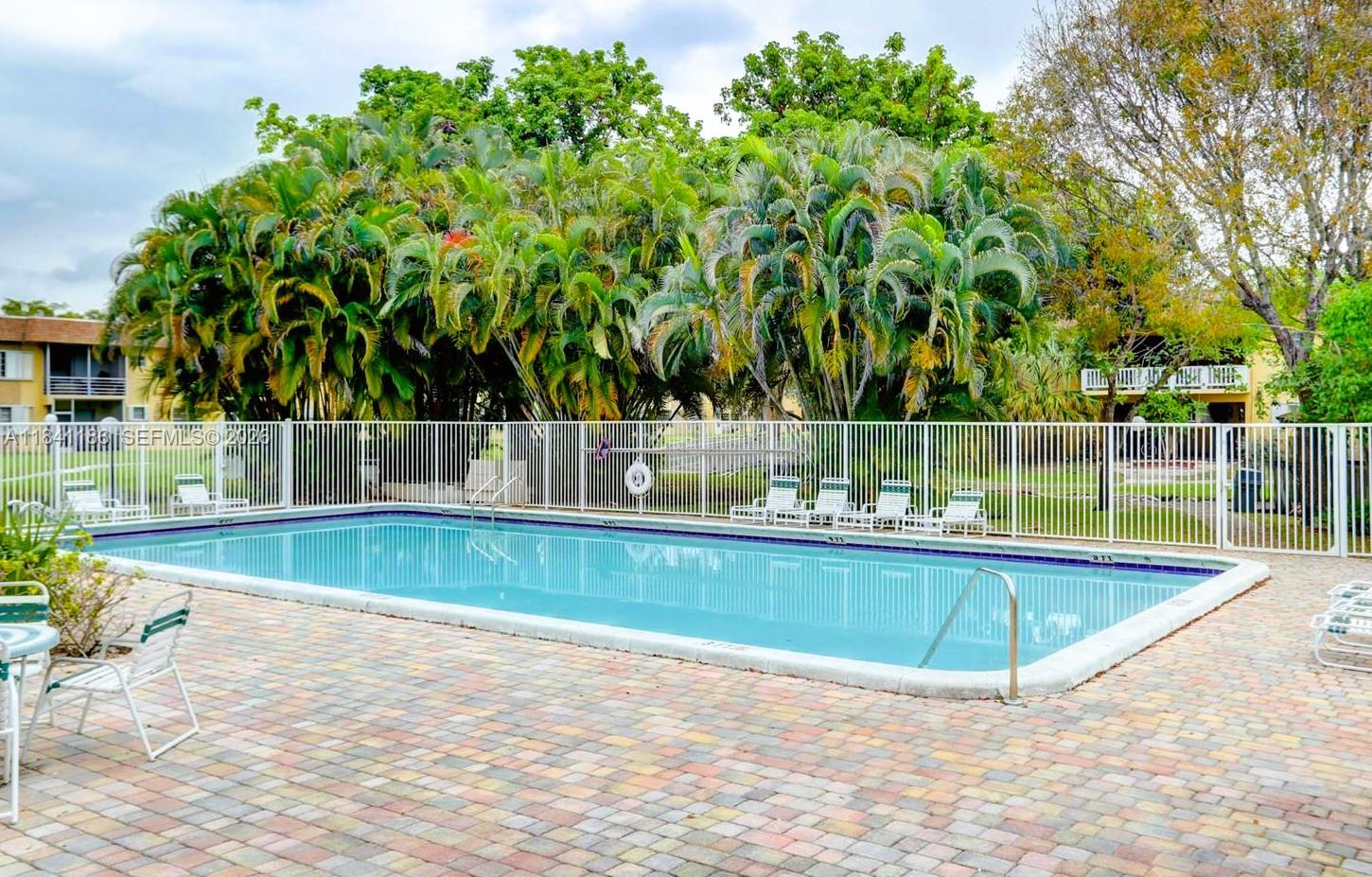 A two-story apartment building with yellow stucco walls, white railings, and a flat roof — 5160 SW 40th Ave # 26D, Dania Beach FL 33314, DANIA BEACH, FL