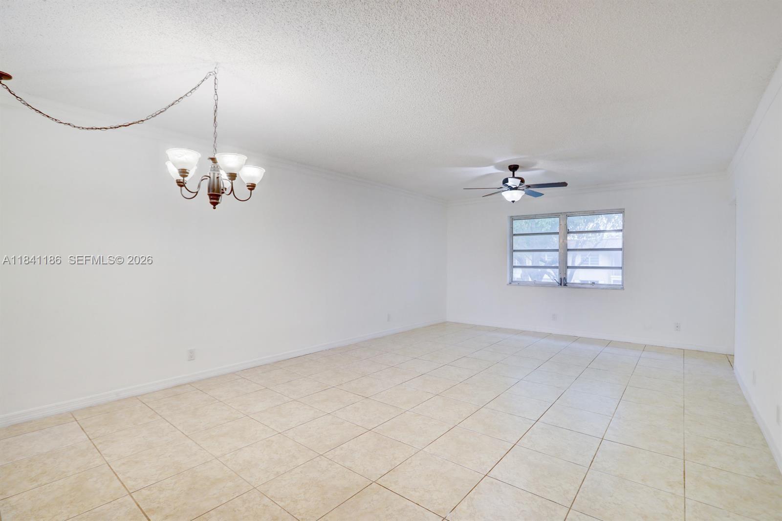 A small pond sits in front of yellow apartment buildings with a pedestrian bridge nearby — 5160 SW 40th Ave # 26D, Dania Beach FL 33314, DANIA BEACH, FL