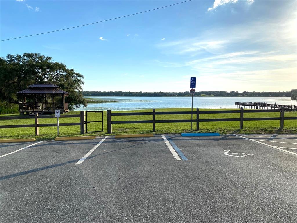 A parking lot with a handicap space overlooks a lake, a gazebo, and a dock — Lots 11.12 SW SHOREWOOD DRIVE, DUNNELLON, FL