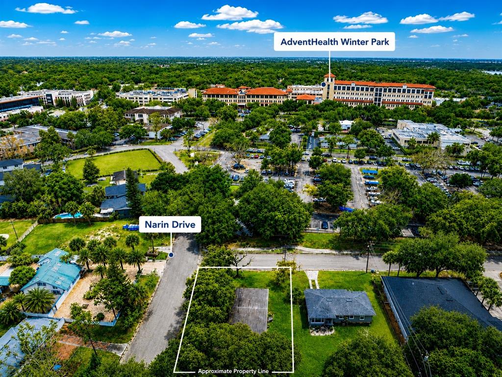 This aerial view shows a vacant residential lot with a small structure near a hospital — 2231 NAIRN DRIVE, WINTER PARK, FL