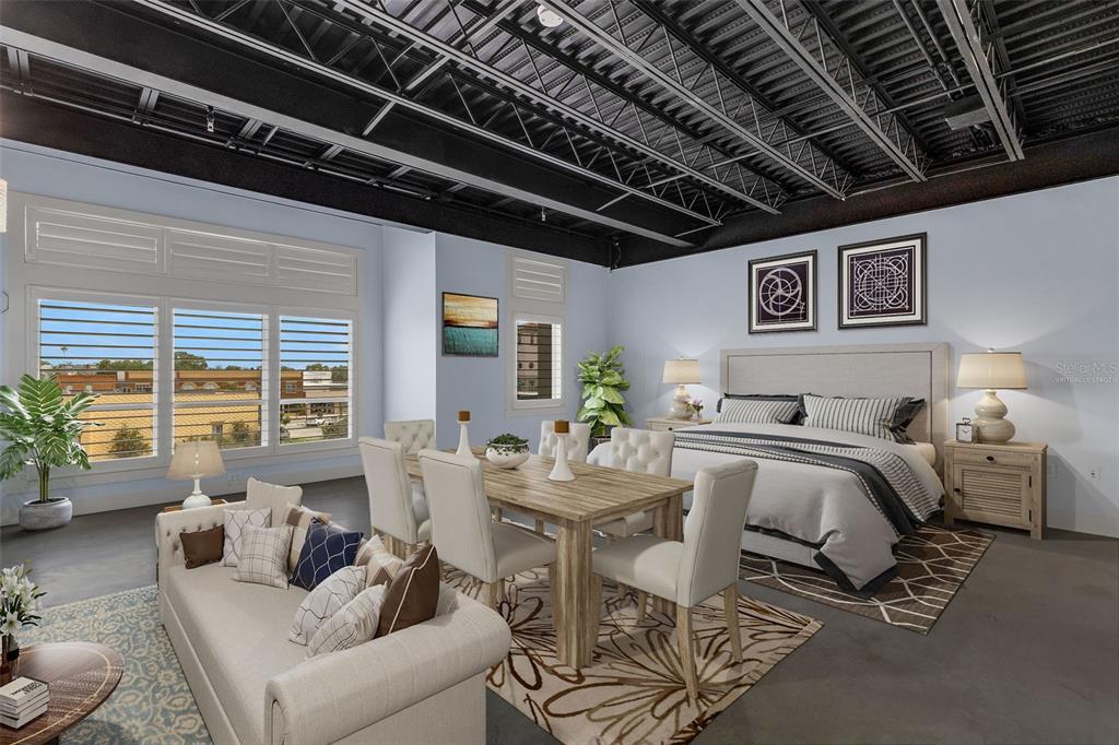 This studio apartment features an exposed ceiling, a dining area, and a bed — 125 N KENTUCKY AVENUE UNIT 303, LAKELAND, FL