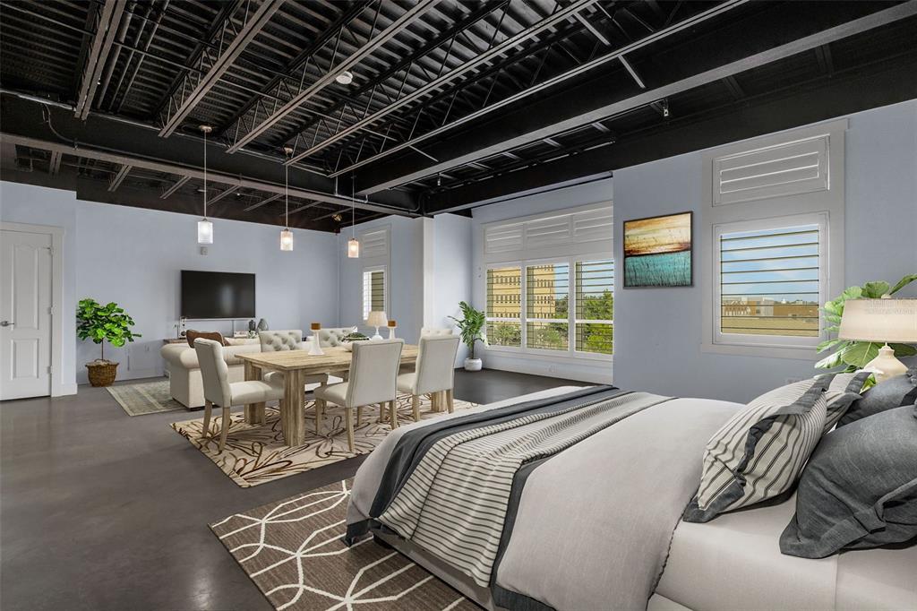 A studio apartment features a bed, dining area, living space, and an exposed black ceiling — 125 N KENTUCKY AVENUE UNIT 303, LAKELAND, FL