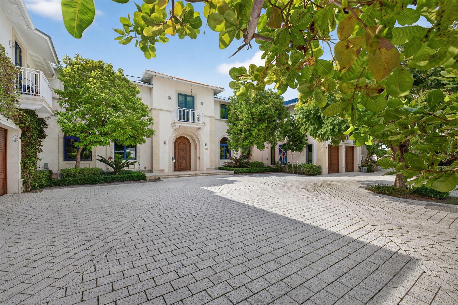 A large, two-story Mediterranean-style house features a paved circular driveway and a wooden front door — 1201 Marble Way, Boca Raton FL 33432, BOCA RATON, FL