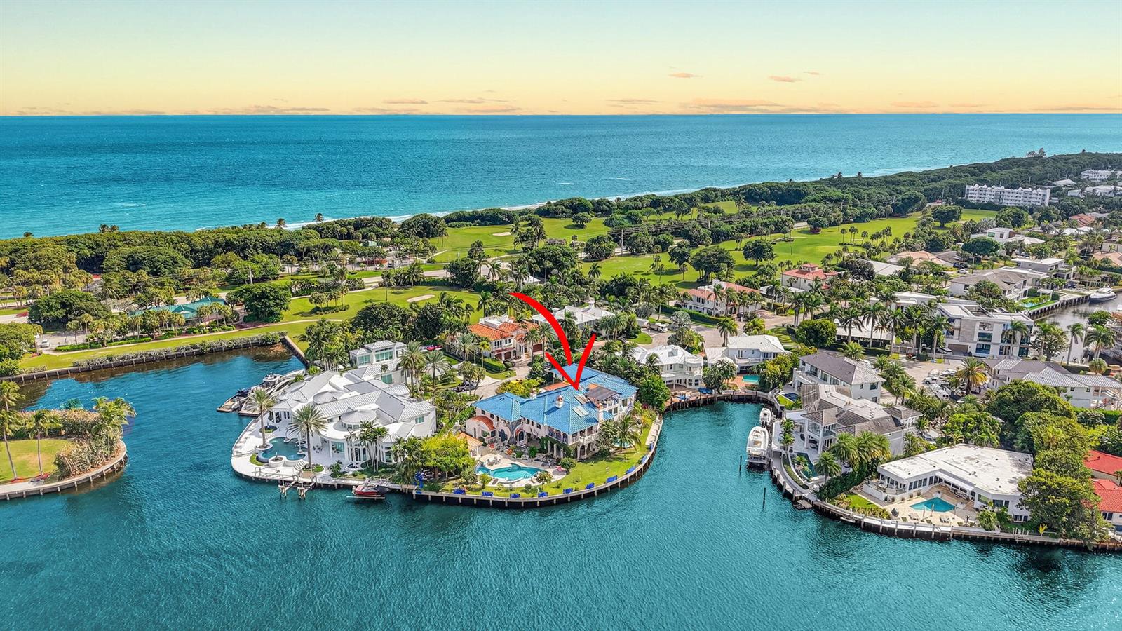 An aerial view shows a waterfront mansion with a blue roof and swimming pool — 1201 Marble Way, Boca Raton FL 33432, BOCA RATON, FL