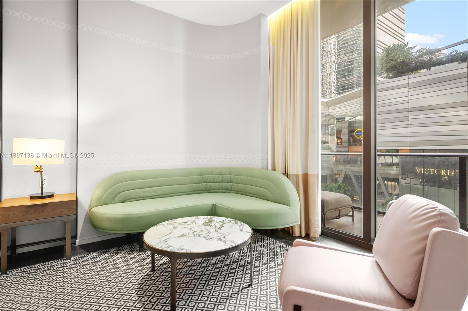 A living area features a curved green sofa, marble coffee table, and a pink armchair — 801 S Miami Ave # 402, Miami FL 33130, MIAMI, FL