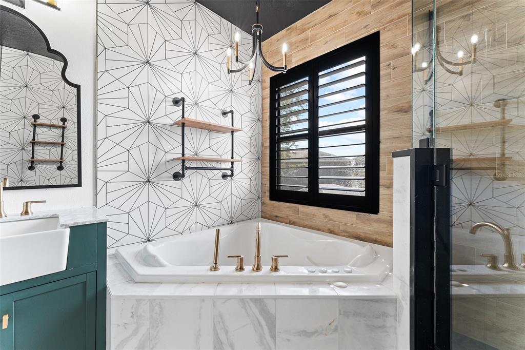 A bathroom vanity with two farmhouse sinks, dark green cabinets, and two arched mirrors — 1291 BLACKRUSH DRIVE, TARPON SPRINGS, FL