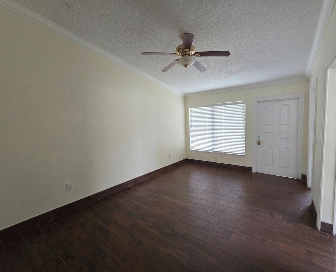 An empty room with dark wood-look tile flooring, cream walls, and a ceiling fan — 3762 Mil Race Court, FL 33463, FL
