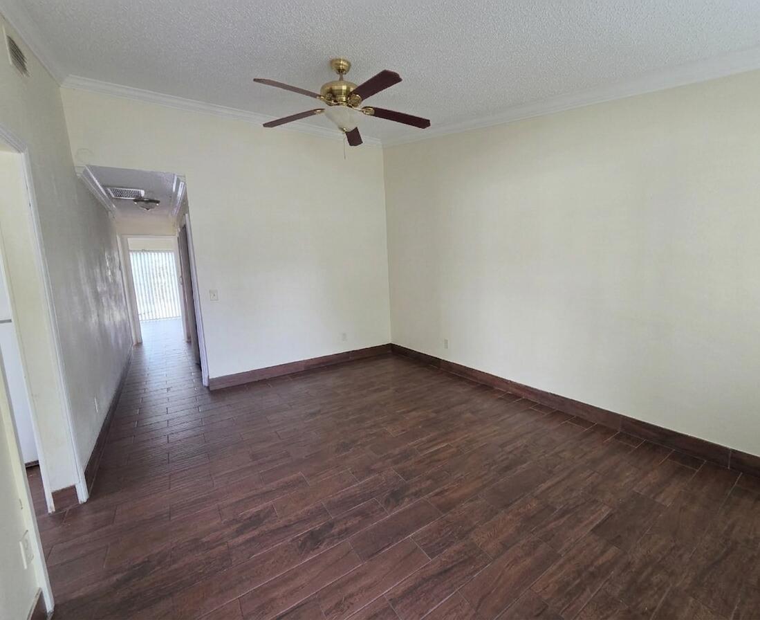 An empty room with wood-look tile flooring, white walls, and a ceiling fan — 3762 Mil Race Court, FL 33463, FL