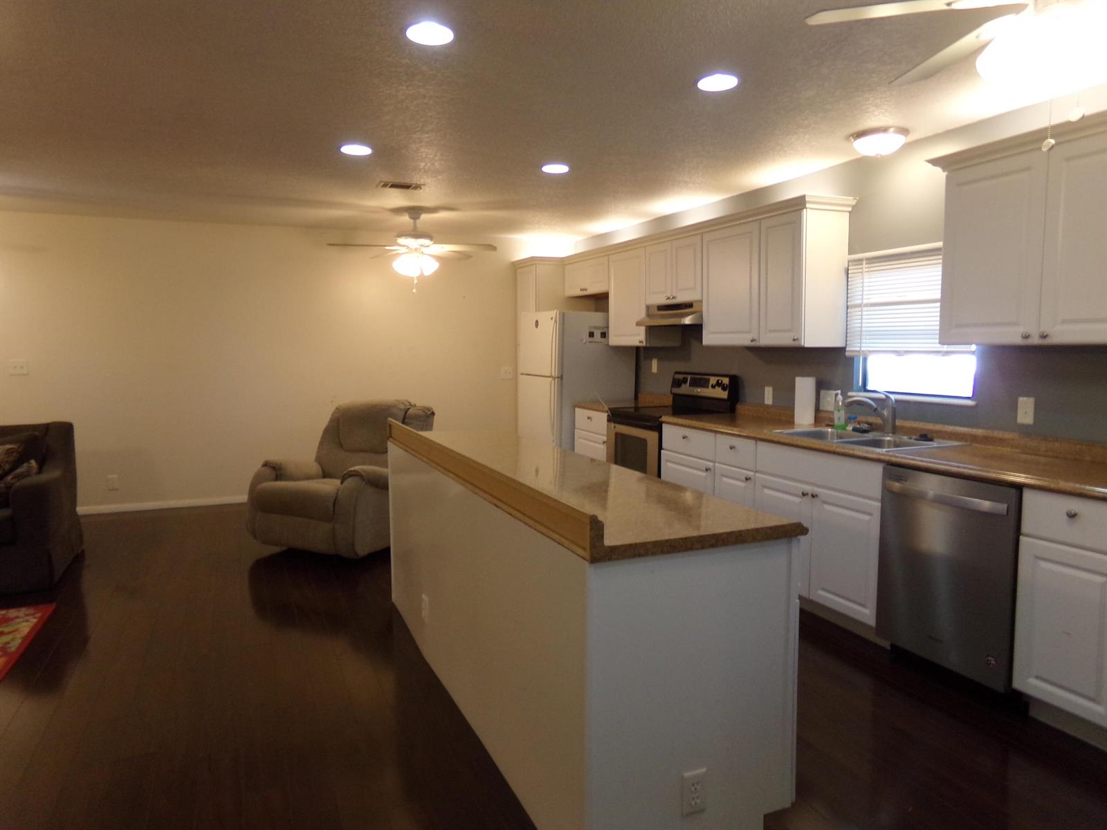 A kitchen with white cabinets, stainless steel appliances, and a breakfast bar island — 52004 Florinada Bay, Boynton Beach FL 33436, BOYNTON BEACH, FL