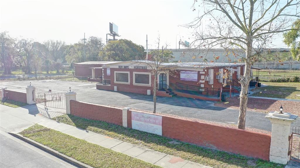 An exterior view of a single-story brick church building with a paved parking lot — 1416 30TH ST, ORLANDO, FL