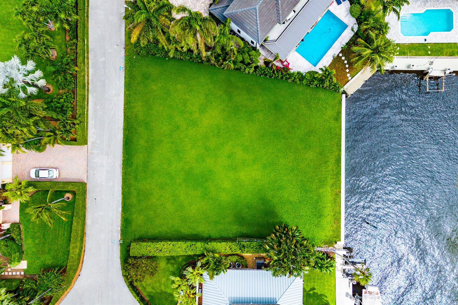 An aerial view shows a vacant, rectangular waterfront lot situated between two residential properties — 29 Hibiscus Way, Ocean Ridge FL 33435, OCEAN RIDGE, FL