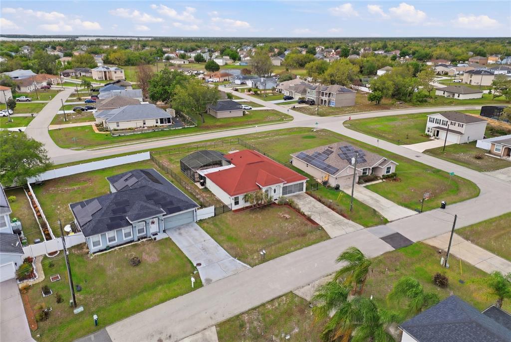 An aerial view shows several suburban houses with driveways and yards in a residential neighborhood — 1912 LAKEVIEW PLACE, KISSIMMEE, FL