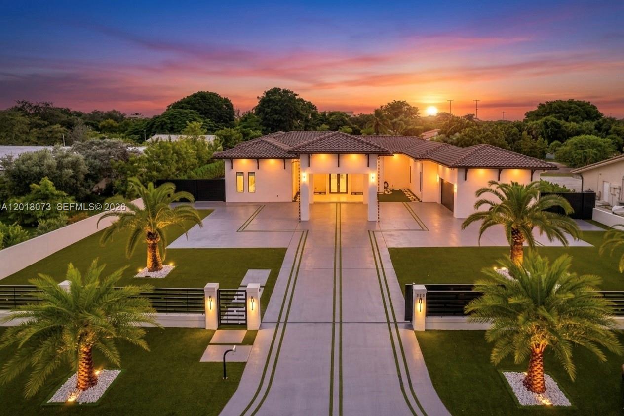 An aerial view of a modern single-story house with a paved driveway and palm trees — 320 SW 125th Ave, Miami FL 33184, MIAMI, FL