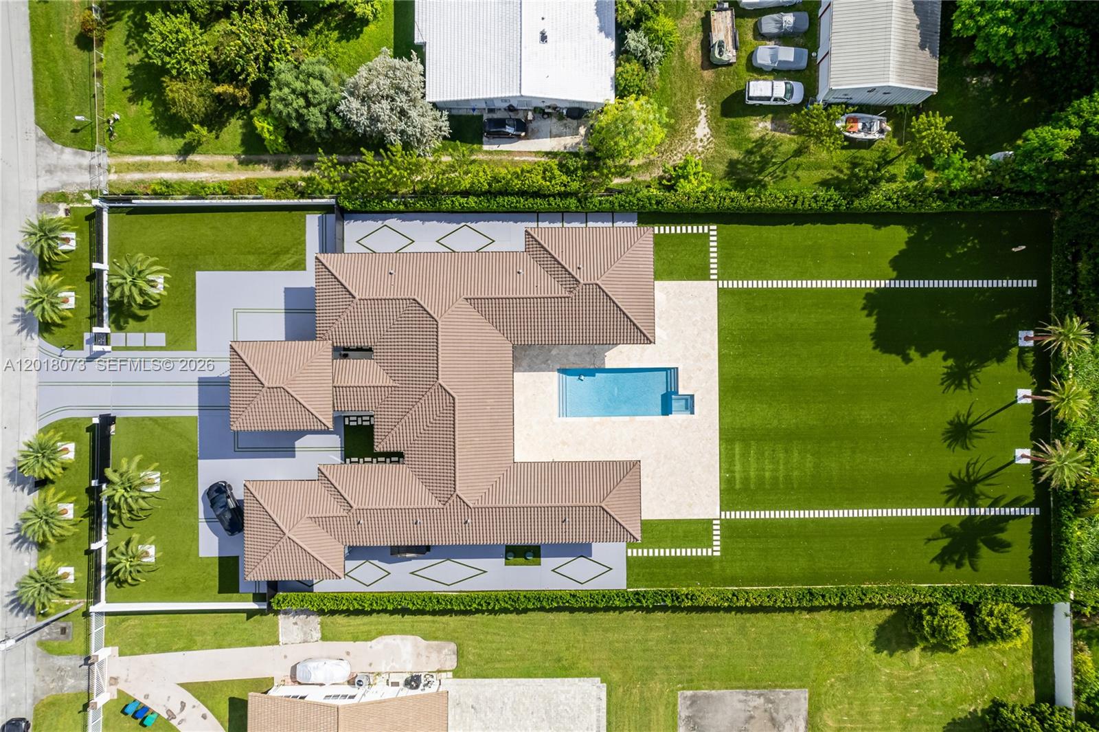 An aerial view shows a house with a tiled roof, pool, and landscaped yard — 320 SW 125th Ave, Miami FL 33184, MIAMI, FL