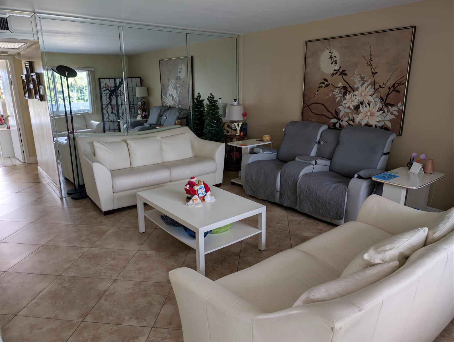 A living room features two white sofas, a gray reclining loveseat, and tiled flooring — 3036 Ventnor H # 3036, Deerfield Beach FL 33442, DEERFIELD BEACH, FL