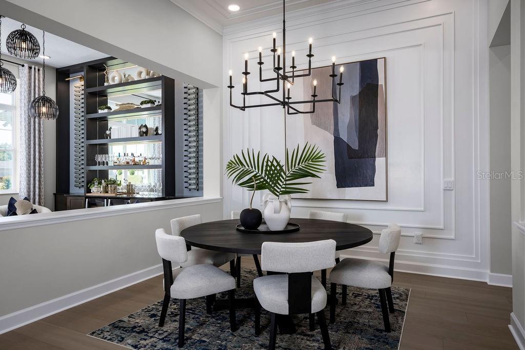 A dining room features a round black table, six upholstered chairs, and a modern chandelier — 3132 SOLACE WAY, ORLANDO, FL