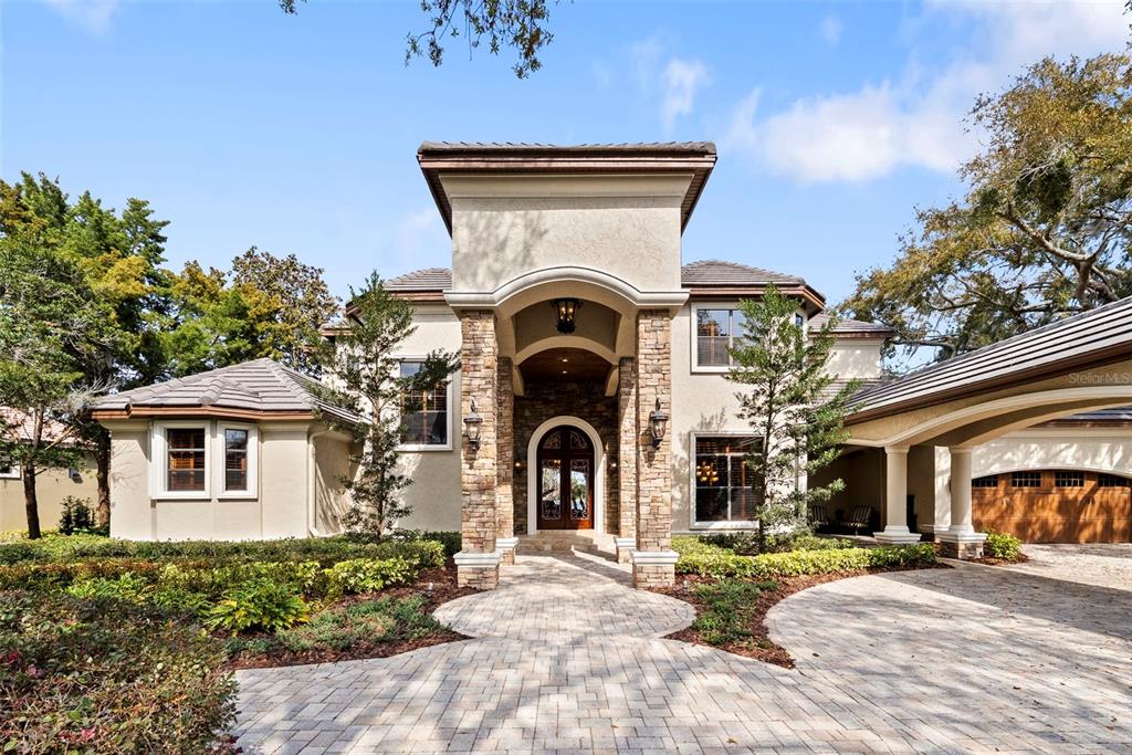 An aerial view shows a two-story house with a backyard pool and a private boat dock — 9902 MENANDER WOOD COURT, ODESSA, FL