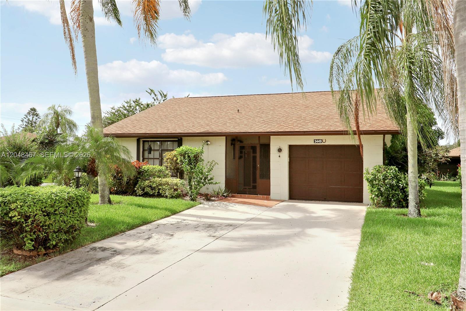 A single-story house with a brown shingle roof, garage, and palm trees in the yard — 3449 Shadow Wood Dr, Green Acres FL 33463, GREEN ACRES, FL