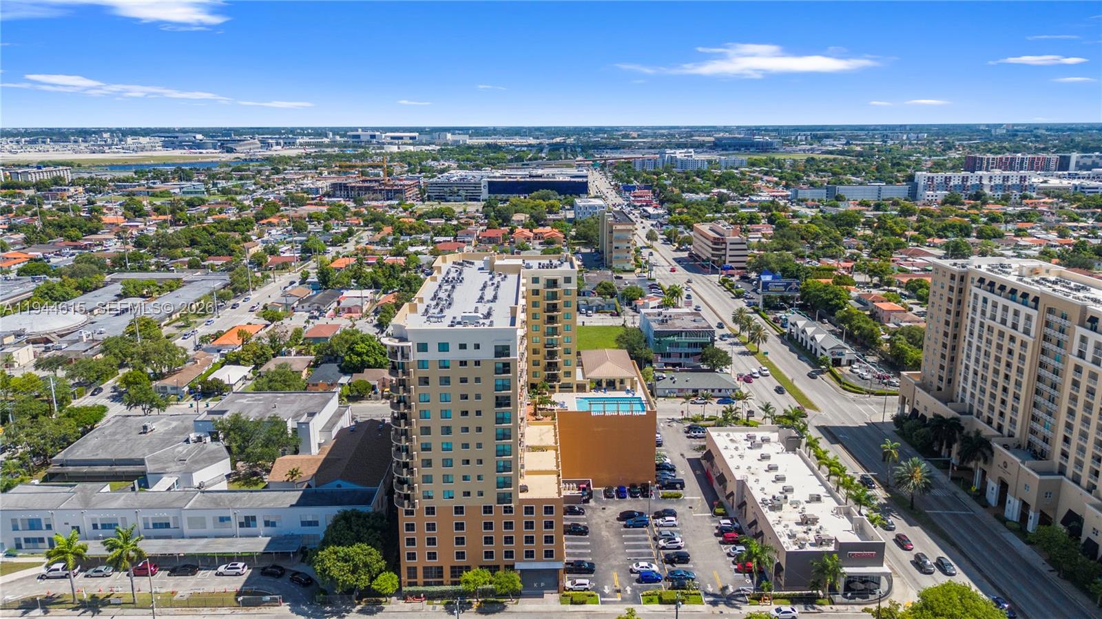 An aerial view shows a tall apartment building with a pool deck and parking lot — 4242 NW 2nd St # 1609, Miami FL 33126, MIAMI, FL