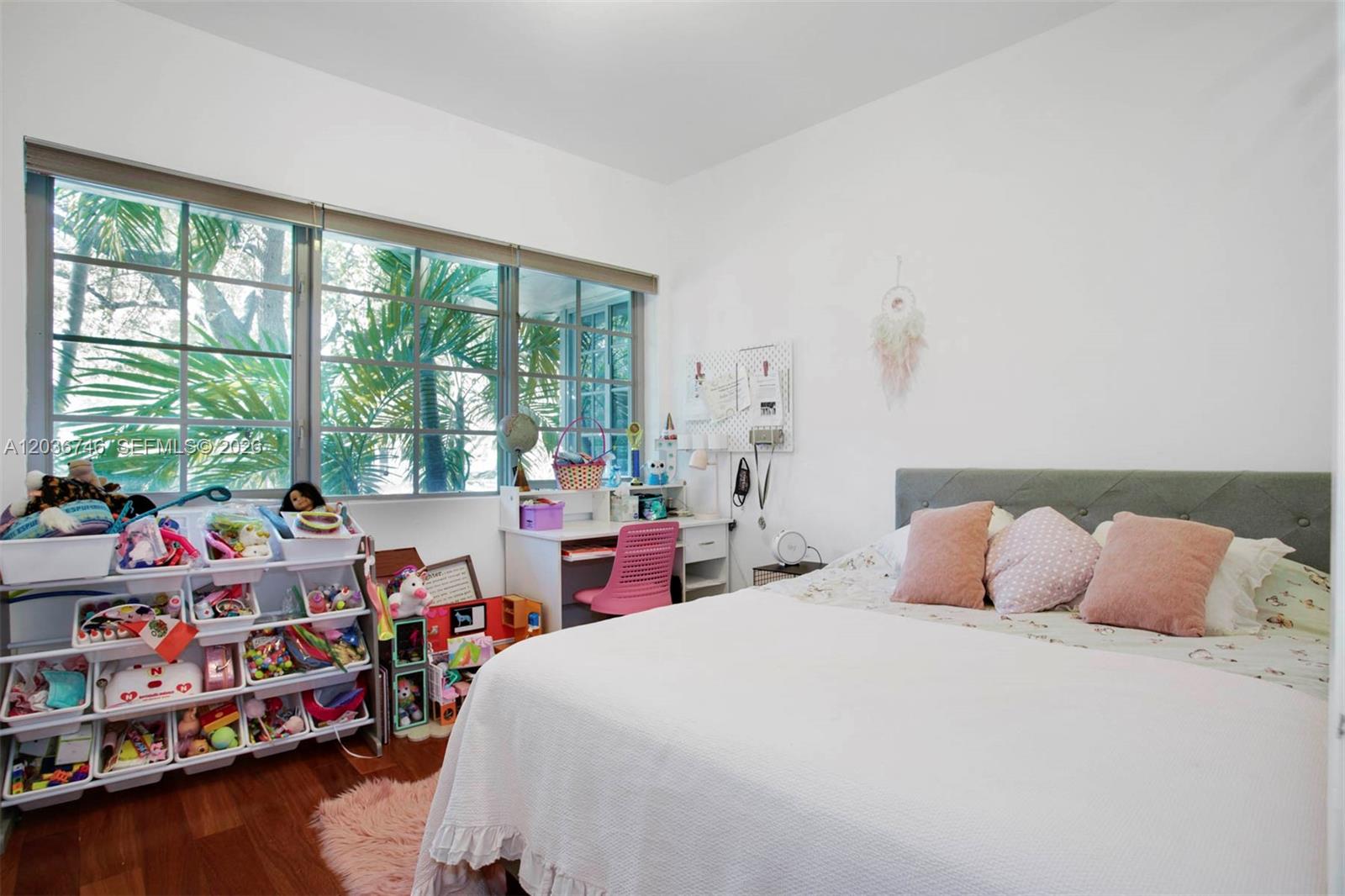 A bedroom features a bed, a desk, and a toy storage unit near large windows — 901 3rd St # 3, Miami Beach FL 33139, MIAMI BEACH, FL