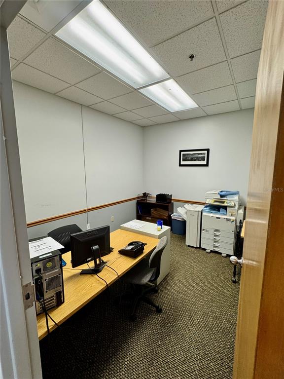 An office space features a wooden desk, a computer, a printer, and a drop ceiling — 2401 FRIST BOULEVARD UNIT #1-2, FORT PIERCE, FL